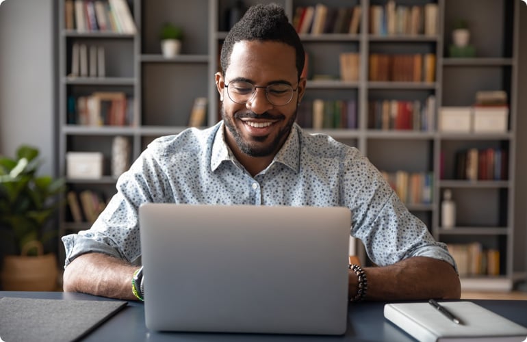 man smiling at the computer