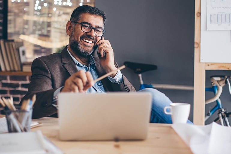 man smiling talking on the phone